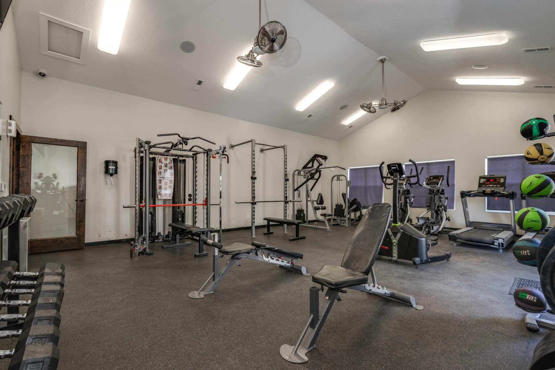 Communities fitness center with modern cardio equipment and weights.
