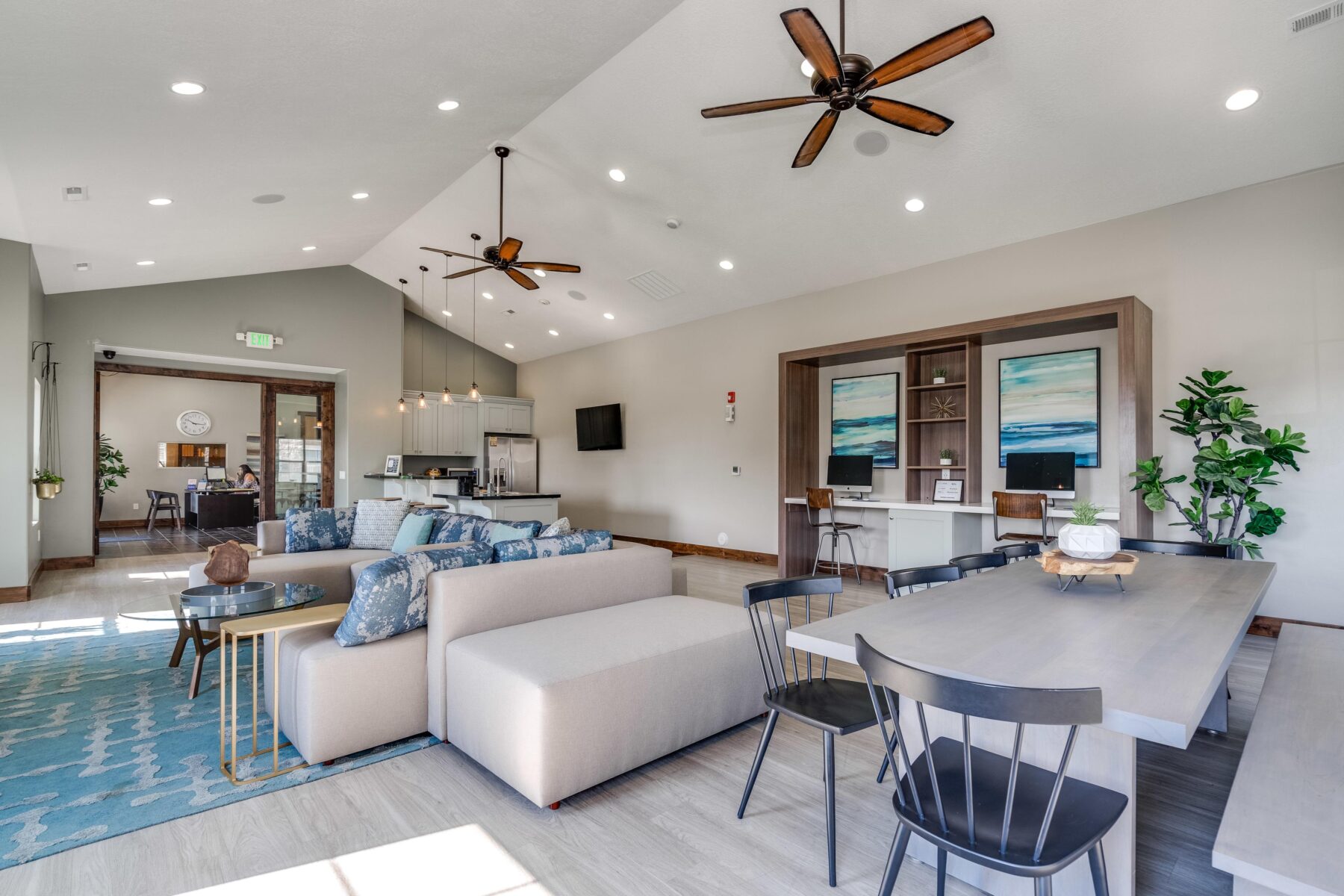 Clubhouse lounge with sofas, tables and computer stations