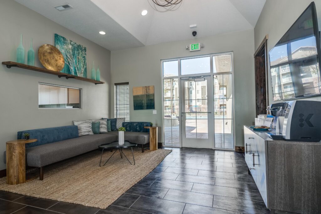 Clubhouse lounge with sofas and TV and coffee station