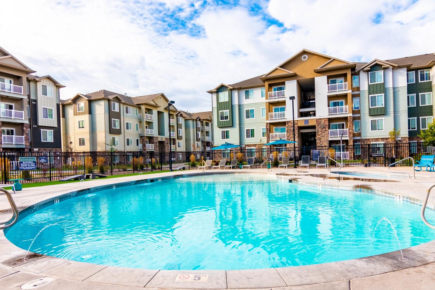 Pool with deck seating and corn hole