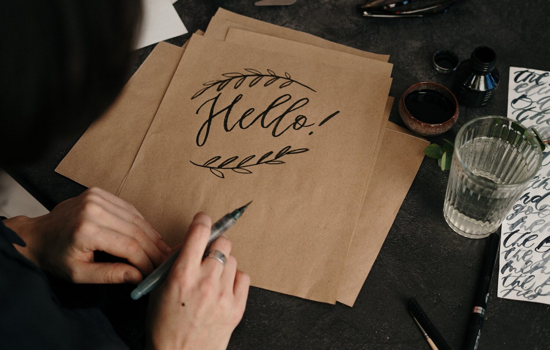 the word Hello written in cursive on a desk