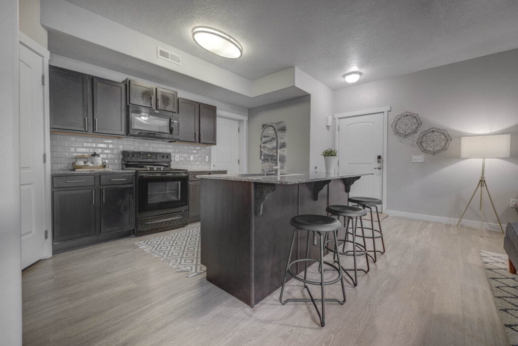 Kitchen with wood cabinets at Sandalwood pet-friendly apartments in West Valley City