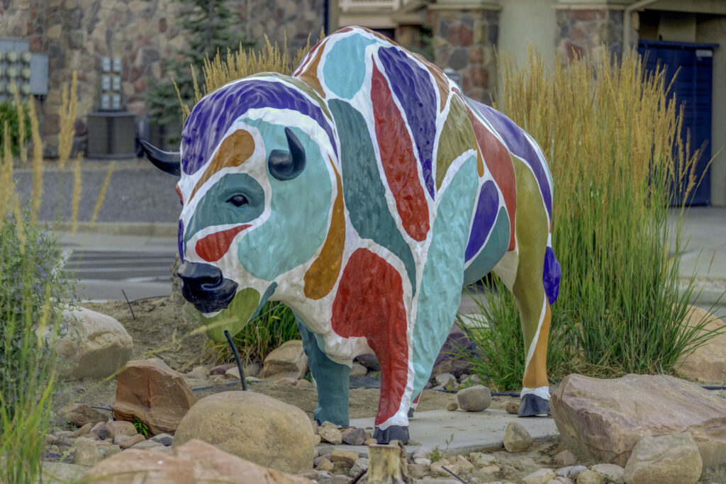 Colorful outdoor sculpture of a bison